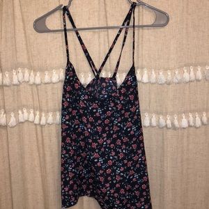 Floral tank top with crisscross straps.